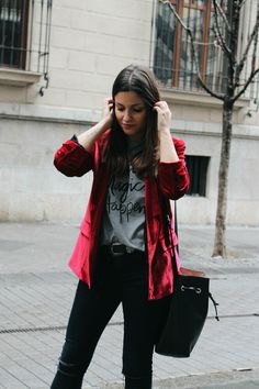 Burgundy velvet jacket worn with a gray graphic t-shirt and black jeans