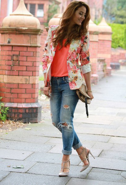 Blush pink floral blazer paired with an orange tank top and ripped jeans