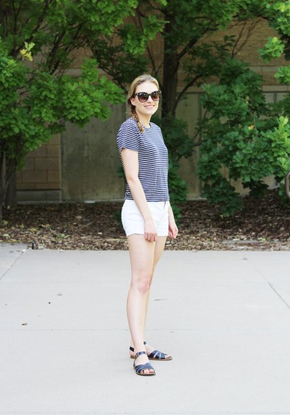 striped t-shirt with white cotton mini shorts and black slide sandals