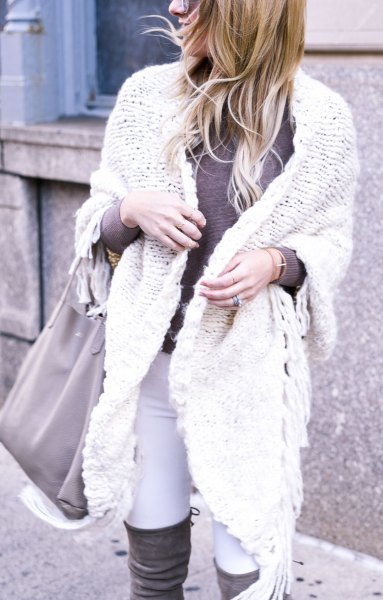 white cable knit sweater with overknee boots