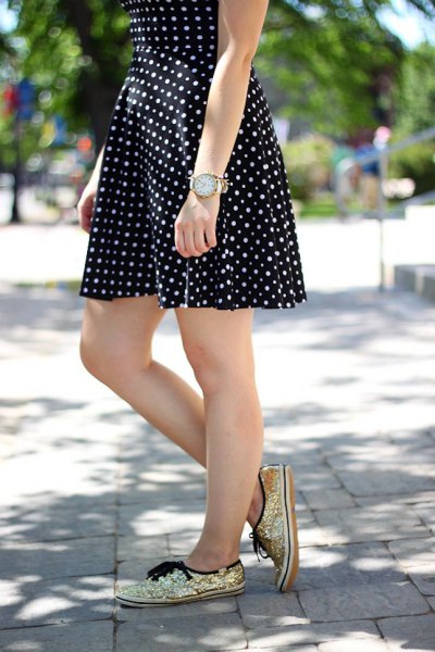 black and white dotted and flared mini dress with golden sequin sneakers