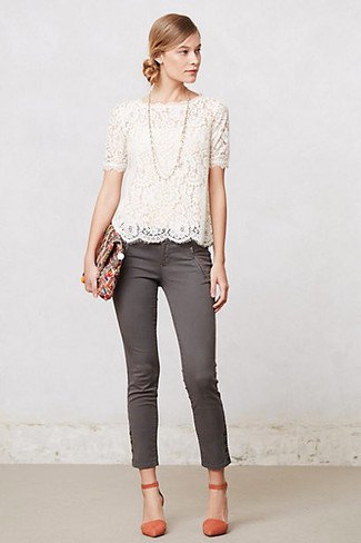 white short-sleeved lace blouse with scalloped hem and gray skinny ankle jeans