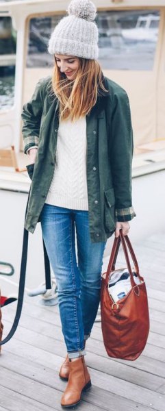 Olive green jacket with white knit sweater and leather boots