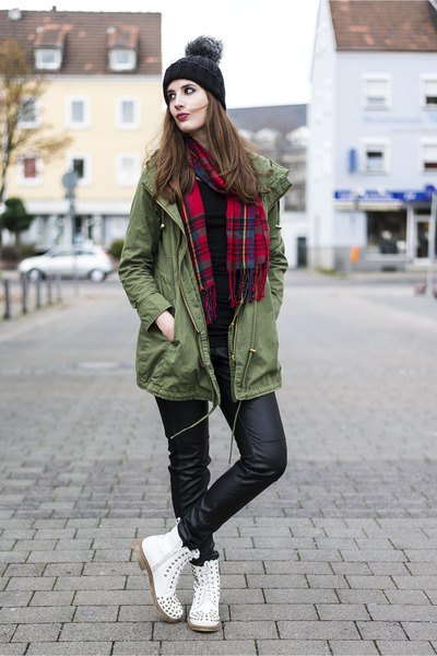 green long jacket with red and black plaid scarf