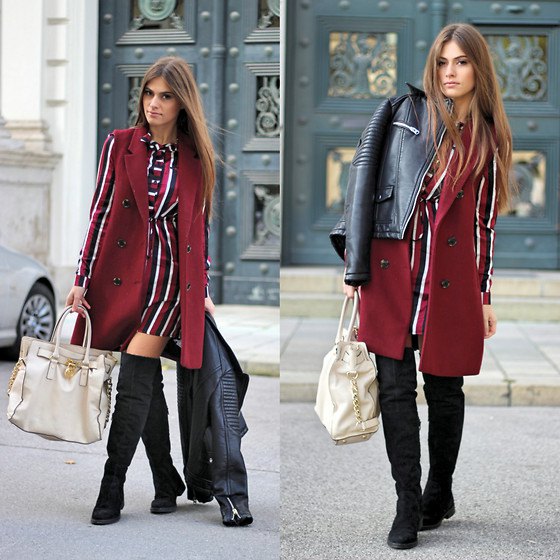 sleeveless burgundy coat over a red, white, and black striped long sleeve dress