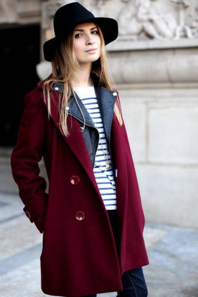 Burgundy trench coat with a black and white striped sweater and felt hat