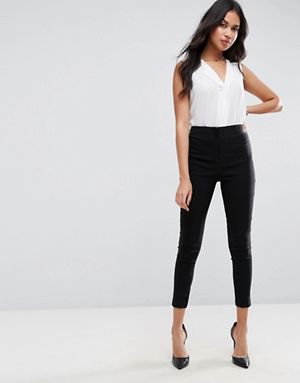 white V-neck sleeveless blouse and black slim-fit pants