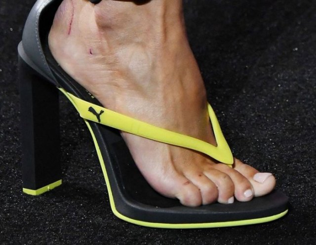 High heel flip flops from the yellow and black sports brand with jogger pants