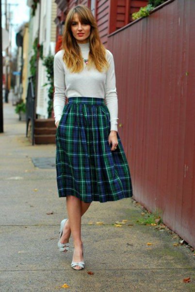 Ivory mock-neck sweater with flared midi check skirt
