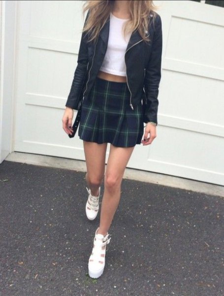 white short t-shirt with black leather jacket and green plaid mini skirt