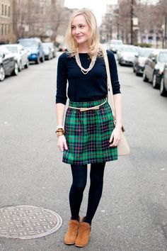 black t-shirt with half sleeves and green and dark blue plaid mini skirt