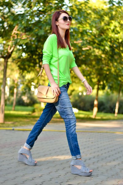 Light green buttonless shirt with slim fit jeans with blue cuffs