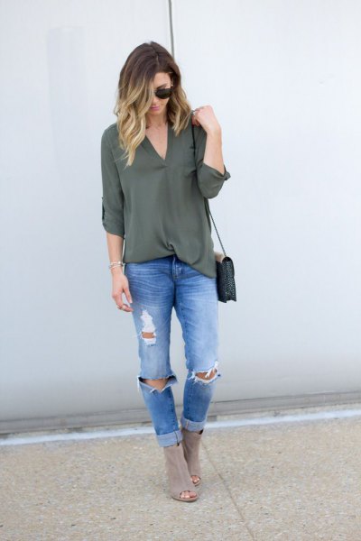 green chiffon layer with blue ripped slim fit jeans and gray boots