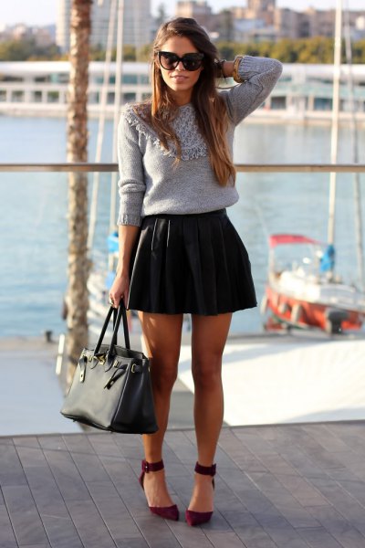gray knit sweater with black pleated leather mini skirt