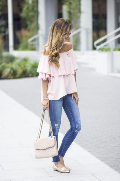 white off the shoulder ruffled blouse with blue jeans and pink slippers