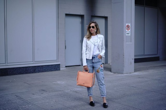 white leather jacket with blue embroidered mom jeans