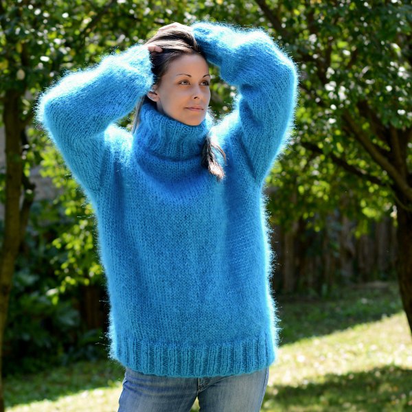 blue turtleneck with a chunky knit sweater and washed skinny jeans