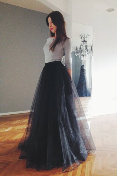 gray, form-fitting sweater with a black, flared skirt made of long tulle