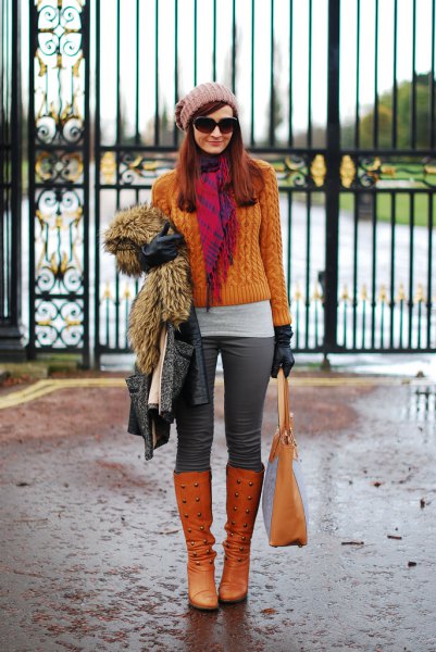 orange cable knit sweater with matching knee high boots