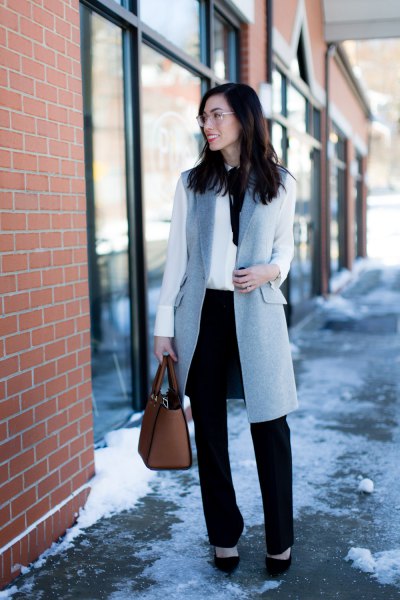 gray wool longline waistcoat with white blouse and black chinos with straight legs