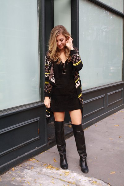 black and yellow printed cardigan with mini sheath dress and long leather boots