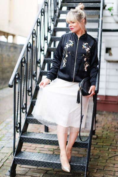 black embroidered bomber jacket, flared white chiffon skirt