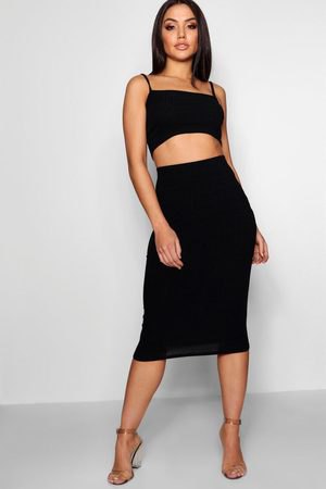 black cropped vest top with square neckline and high-waisted, form-fitting midi skirt