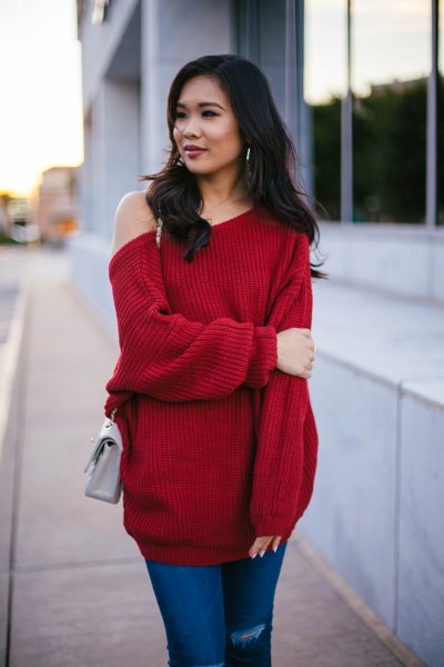 red chunky tunic sweater with blue jeans