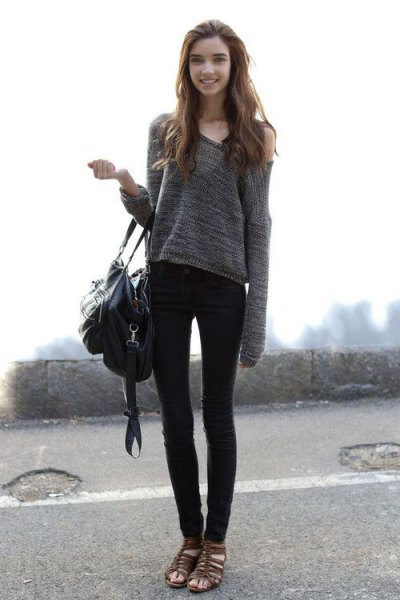 gray off the shoulder one shoulder sweater and black skinny jeans