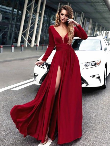 Red maxi dress with a deep V-neckline and long sleeves and a high slit