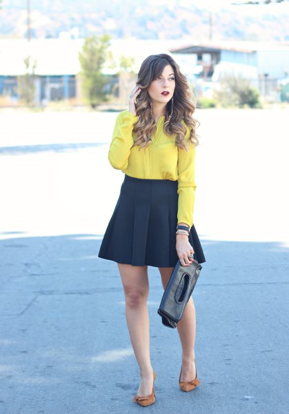 yellow button down shirt and black flared mini and pleated skirt