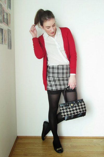 black and white checked figure-hugging mini skirt, red cardigan