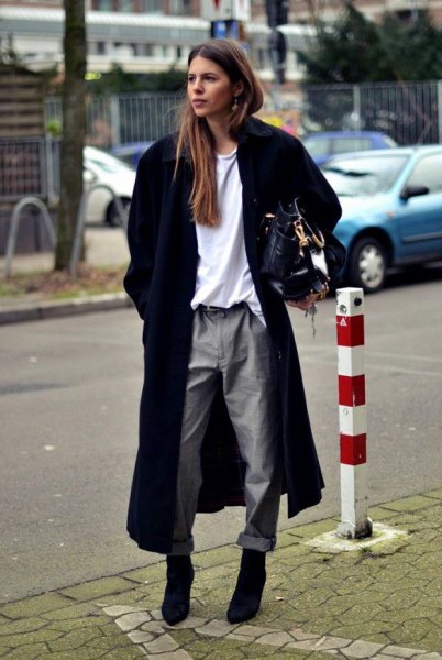 long black wool coat with white sweatshirt and gray straight leg trousers