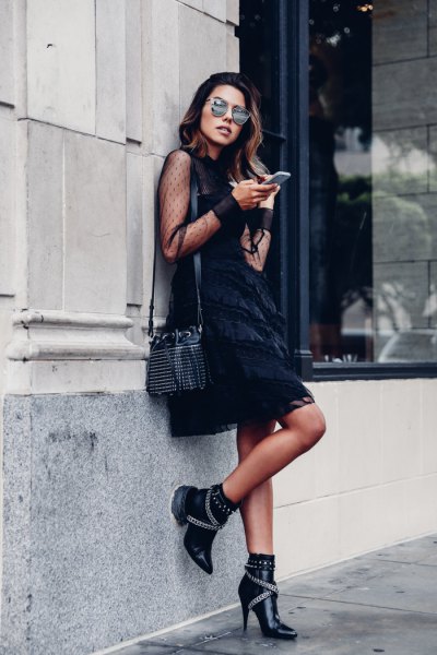 black semi-transparent mini swing dress with short leather boots