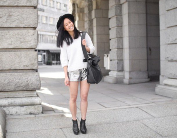 white knit sweater with half sleeves, silver shorts and felt hat