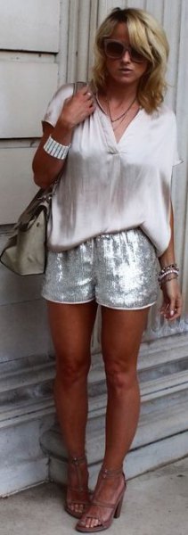 white short sleeve blouse with silver sequin shorts