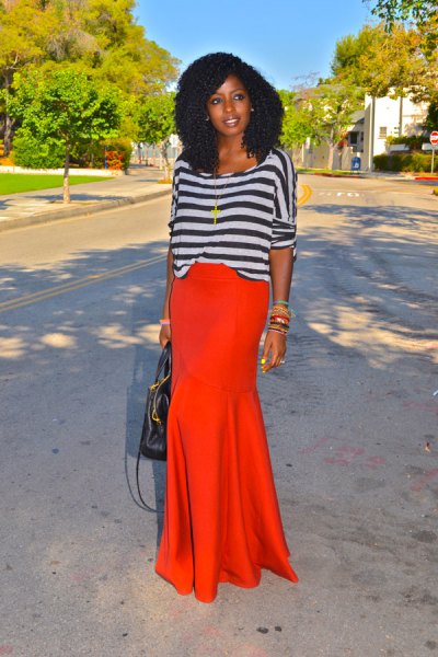 gray and black striped long sleeve boat neck top with orange maxi skirt