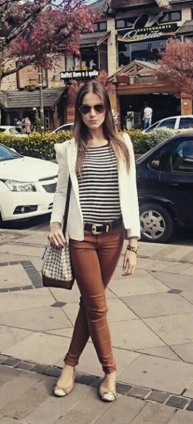 striped t-shirt with white blazer and brown jeans