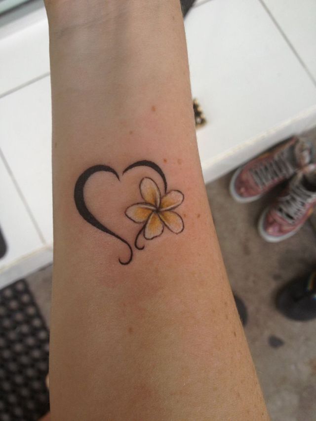 Plumeria with heart tattoo on wrist