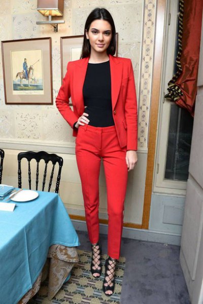black crew neck t-shirt, red suit and strappy open toe heels