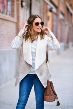 gray and white sherpa vest with striped long-sleeved t-shirt