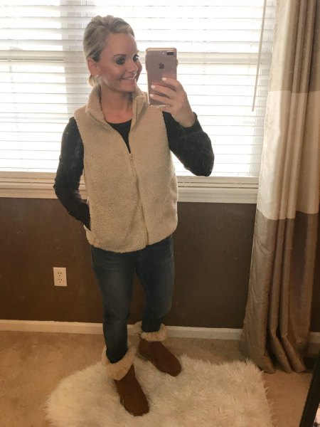 blush pink zip-up vest, blue skinny jeans and fur boots