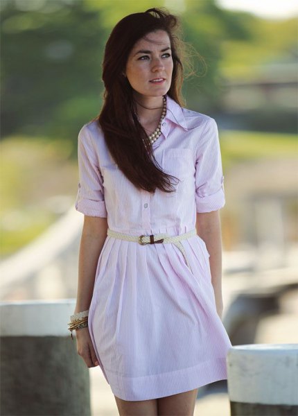 Light pink mini dress with button closure and statement silver chain