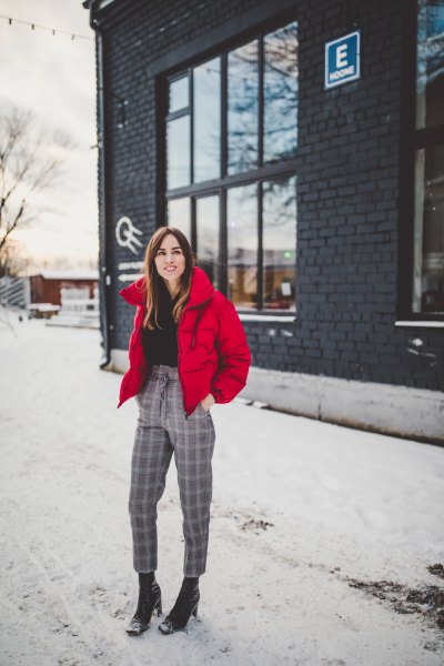 red padded jacket with black mock-neck sweater and plaid cropped pants