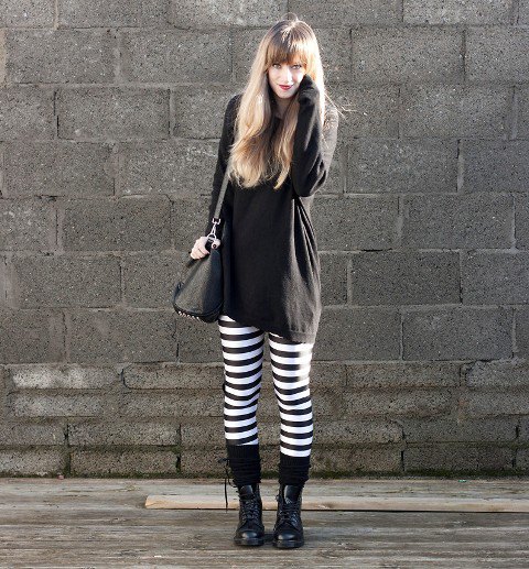 black tunic sweatshirt with striped leggings and mid-calf boots