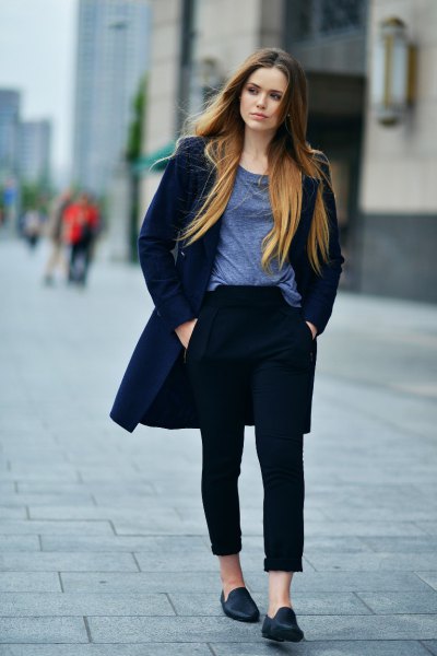 Dark blue longline coat with black cuffed jeans and casual slippers