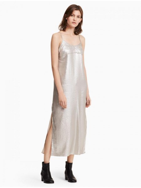 silver maxi dress with spaghetti straps and scoop neckline and black leather ankle boots