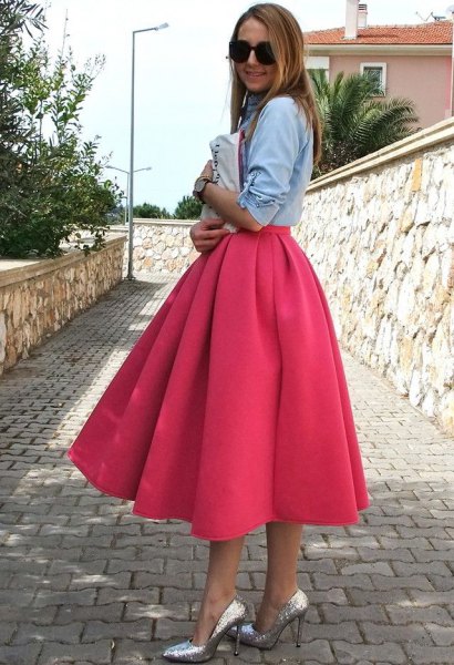 Light blue chambray shirt paired with a flared pink midi dress and silver heels