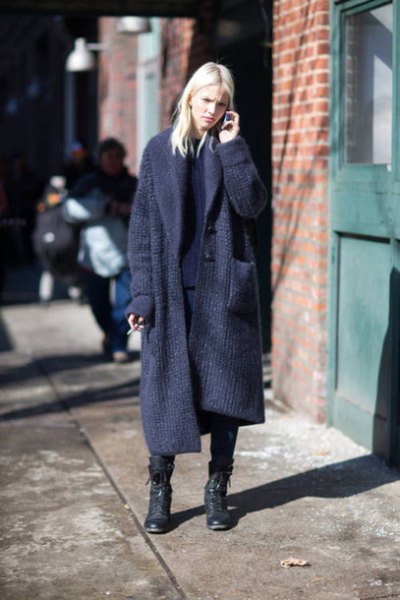 Dark blue knit sweater with maxi tear and black combat boots