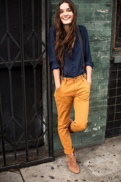 black button down shirt and mustard yellow jeans